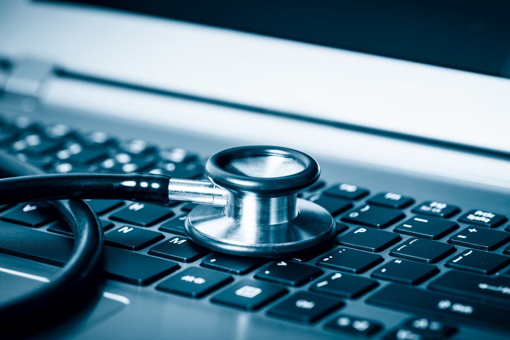 Graphic of a computer keyboard with a stethoscope, symbolizing a technical website health check.